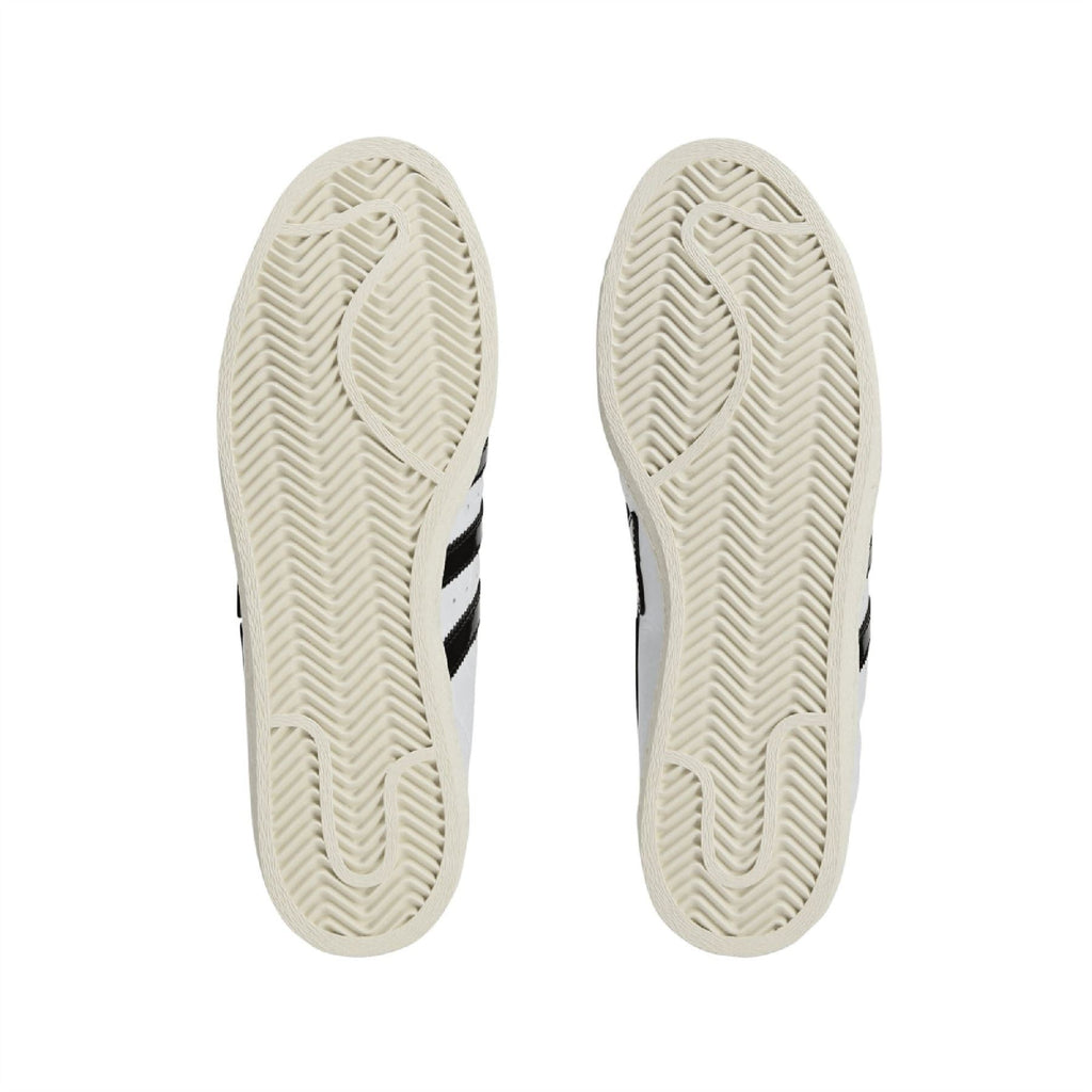 White rubber outsoles with herringbone tread and black sidewall trim