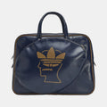 Navy duffel bag with top handles, side zips, and gold Trefoil head logo on front.
