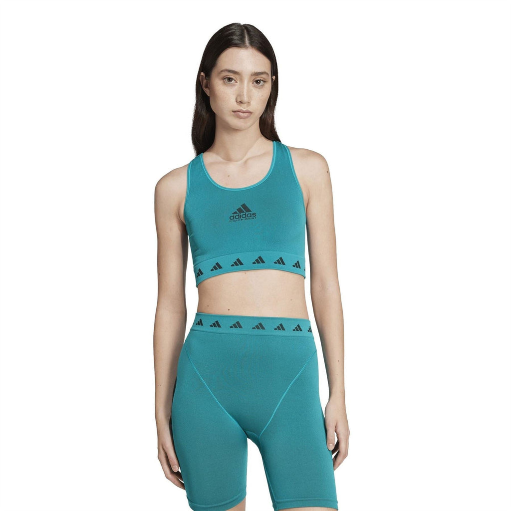 Teal cropped tank with adidas logo and patterned hem band; worn with matching shorts