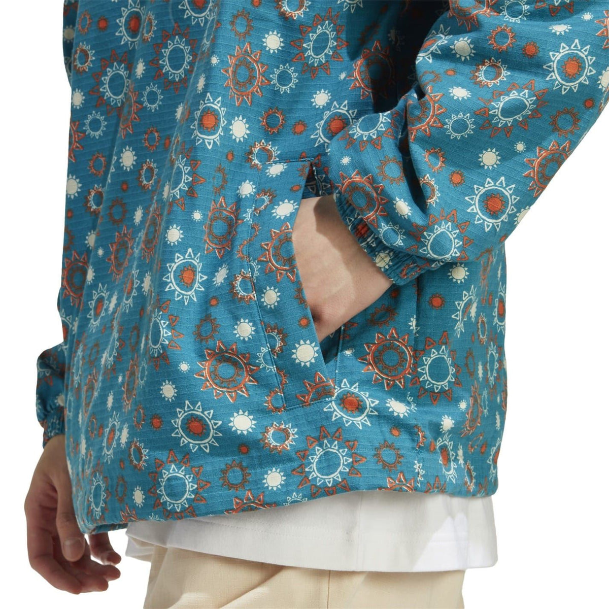 adidas hooded quarter-zip relaxed shirt close-up, teal printed fabric and long sleeves