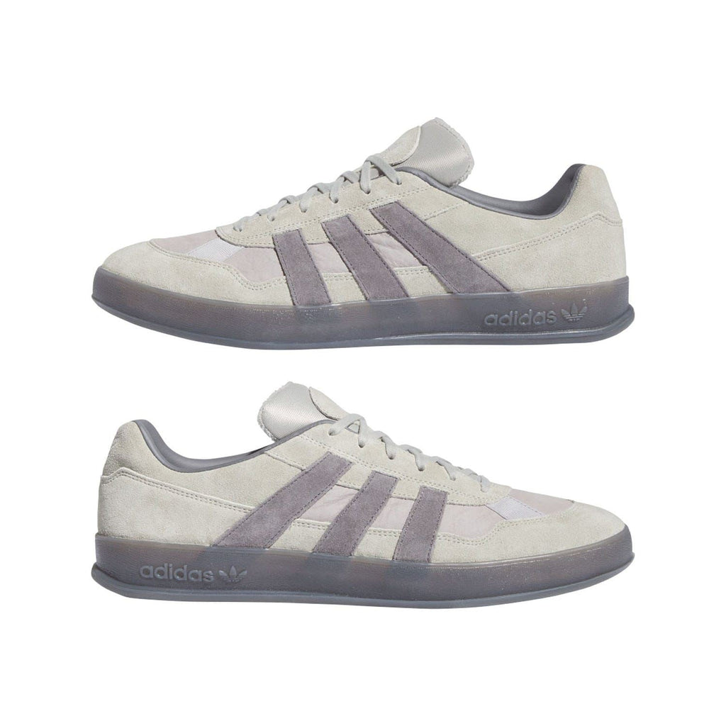 Pair of beige adidas Originals Aloha Super Trainer sneakers with purple stripe details