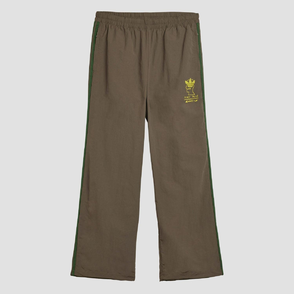 Chocolate track pants with elastic waist and green side stripes, yellow logo print