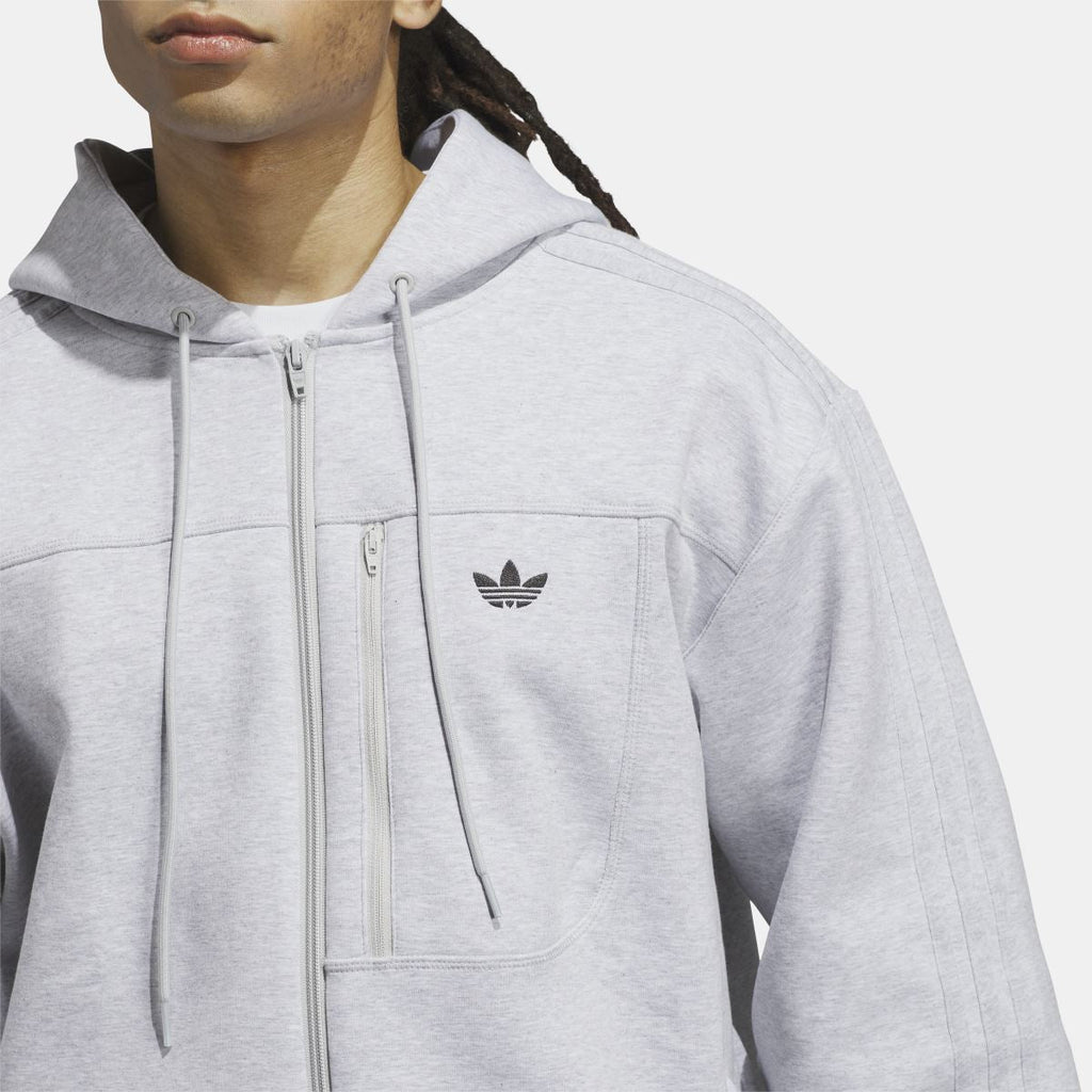 Grey fleece hoodie close-up with zip, hood drawcords, and adidas trefoil chest logo.