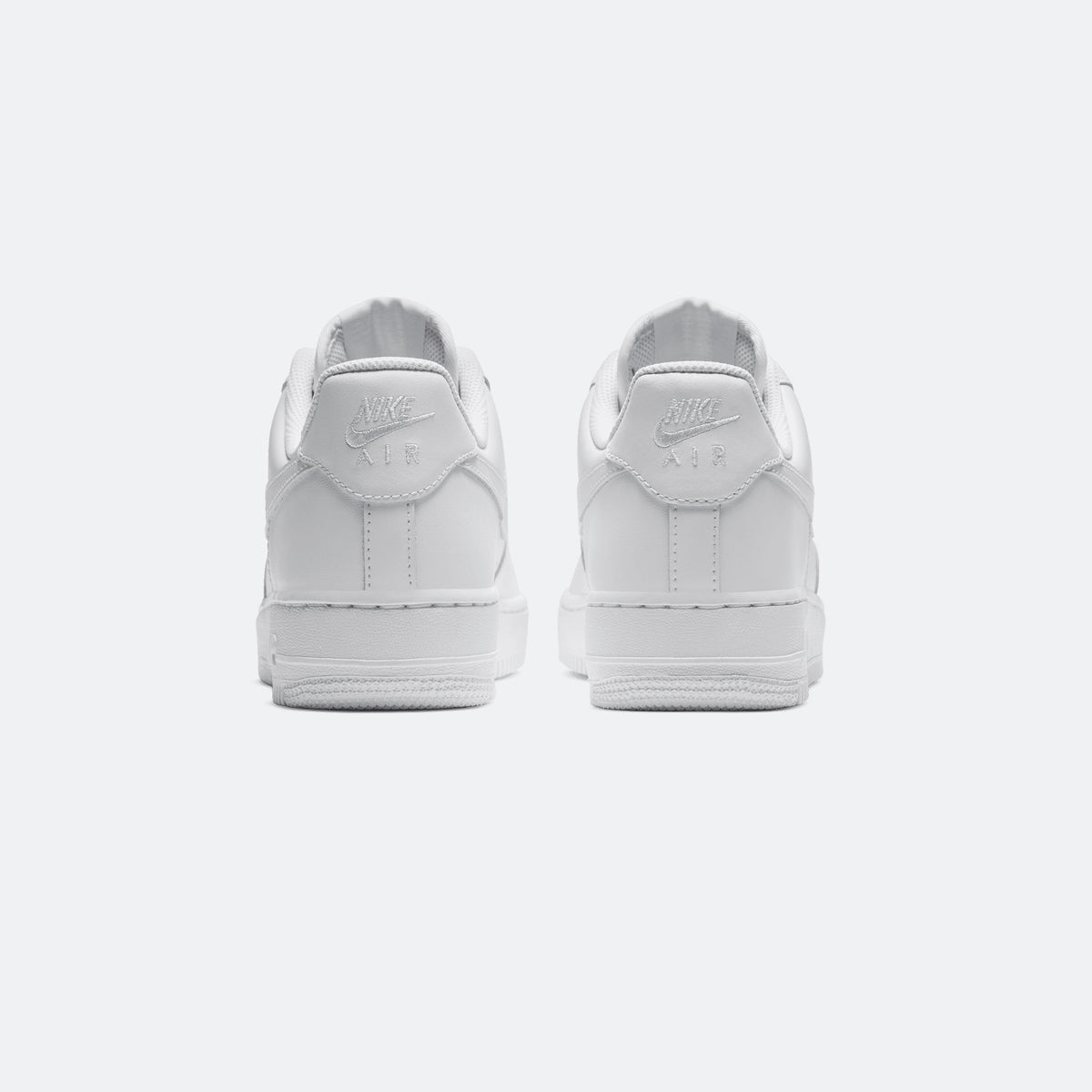 White Nike Air Force 1 low-top sneakers, heel view with Nike logo and padded collar