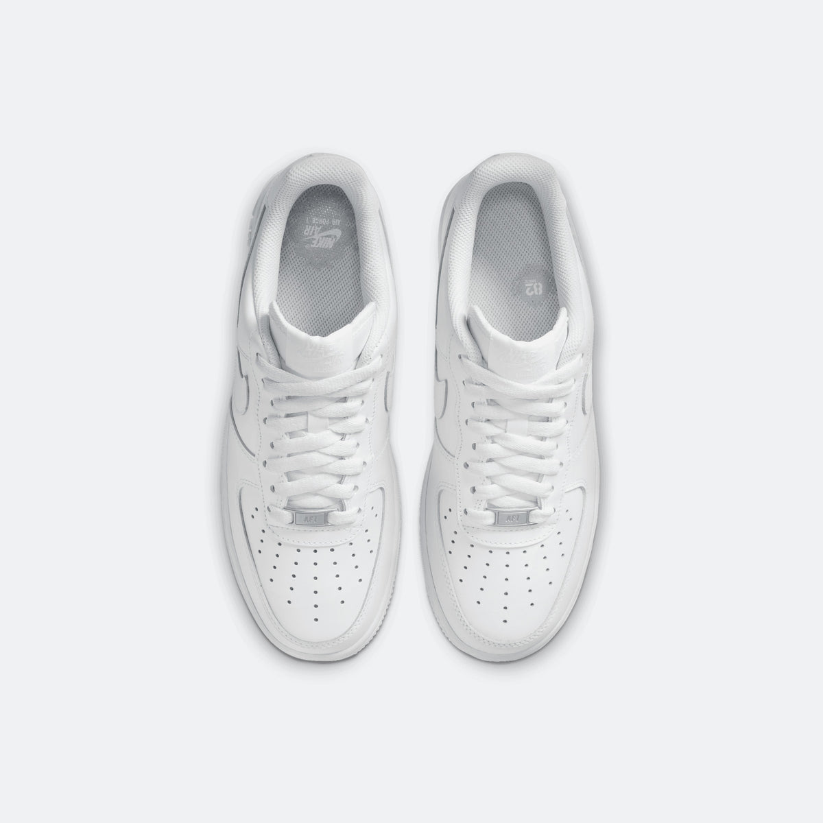 White Nike Air Force 1 low-top sneakers, top view of lace-up uppers and perforations