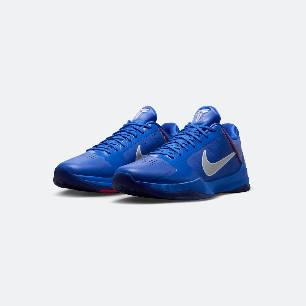 Blue Kobe V Protro basketball shoes, lace-up design with Swoosh and red accents