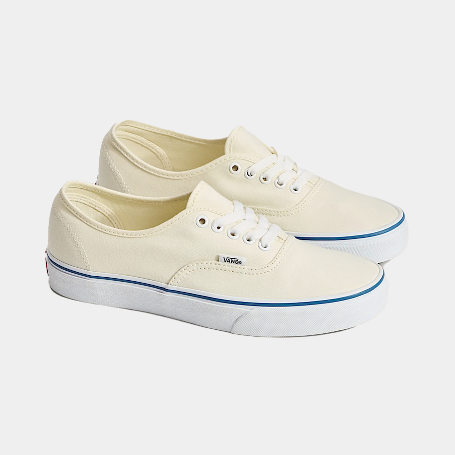 Cream canvas low-top sneakers, side view with white laces and blue trim