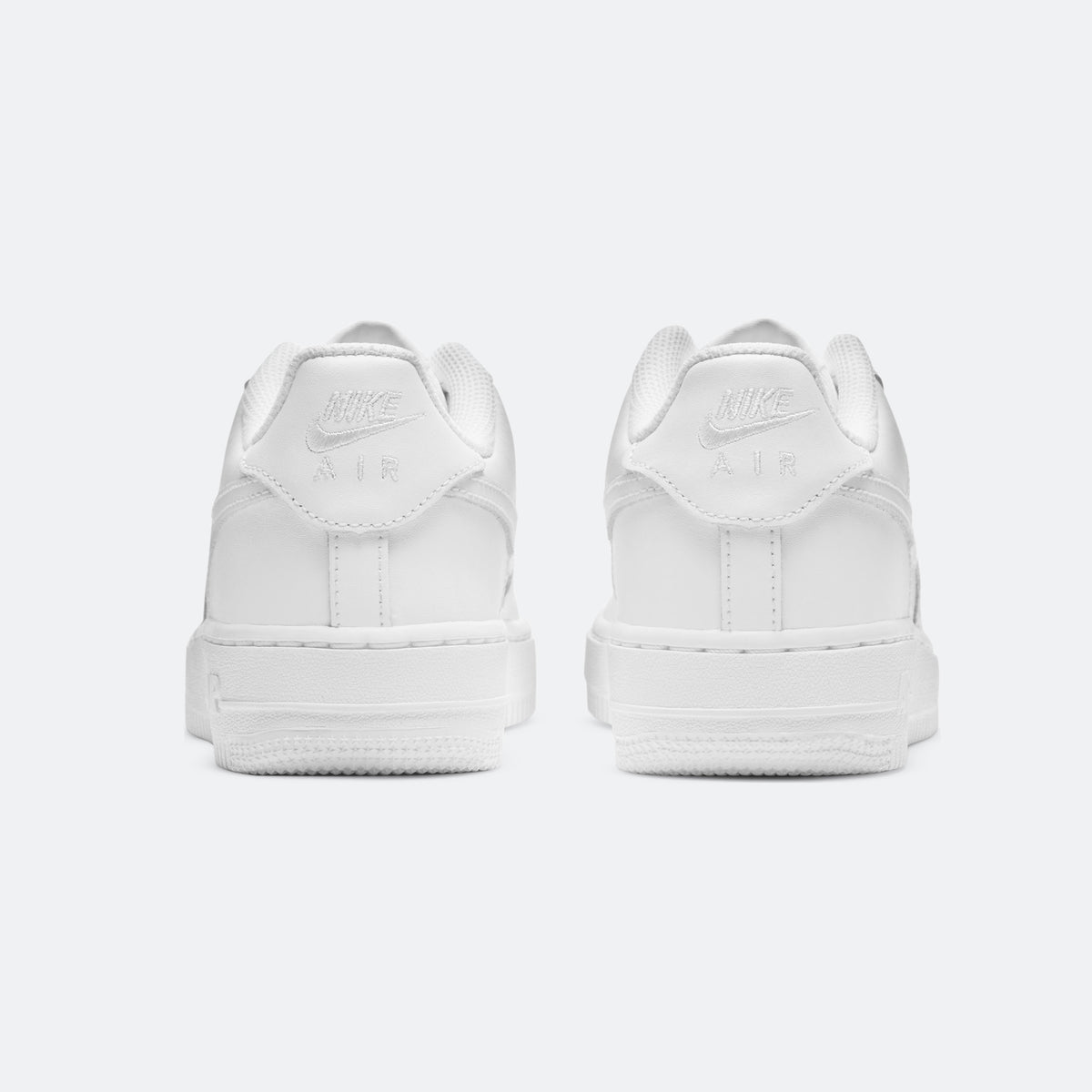 White Nike Air Force 1 sneakers, rear view with padded heel and lace panels