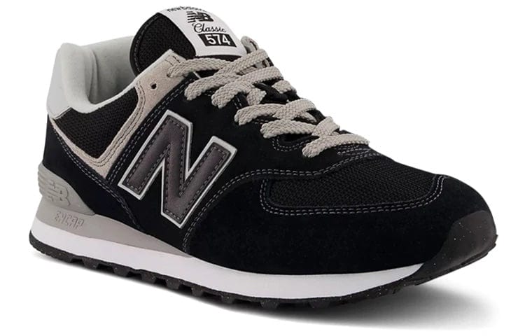 Black sneakers with gray tongue, white laces, and large N side logo