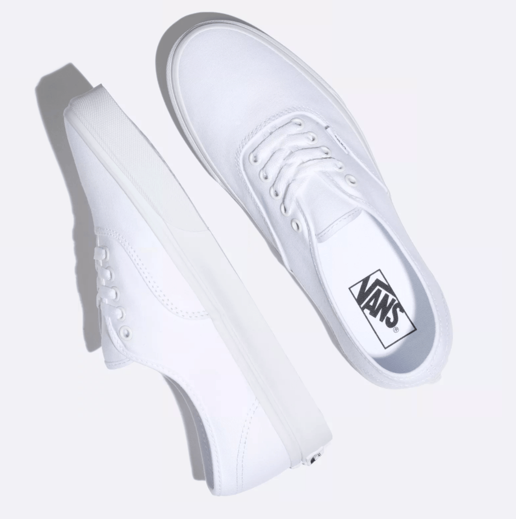 White low-top sneaker pair angled view with Vans side label and lace panel