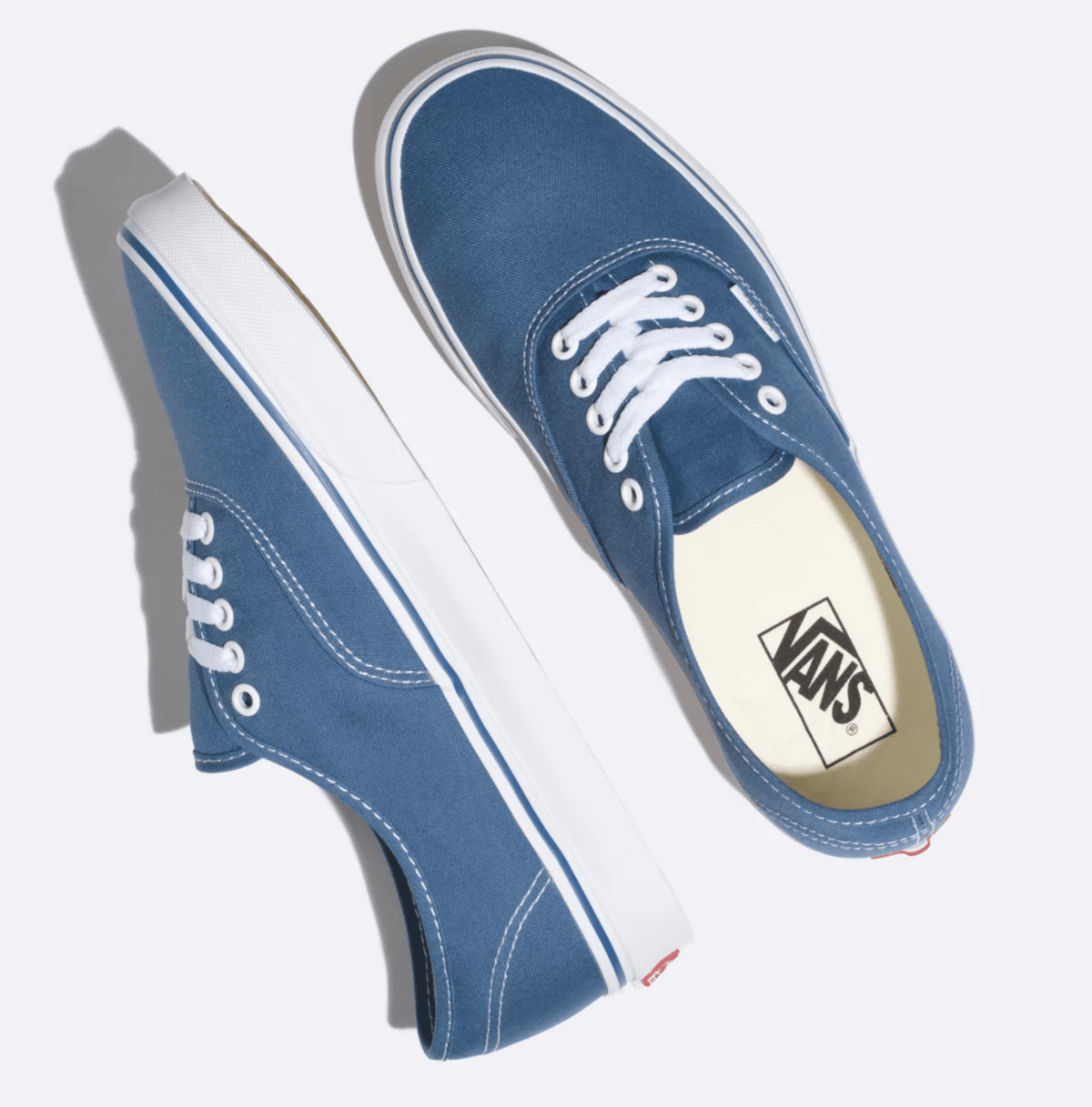 Navy canvas low-top sneakers shown in angled top view with Vans logo