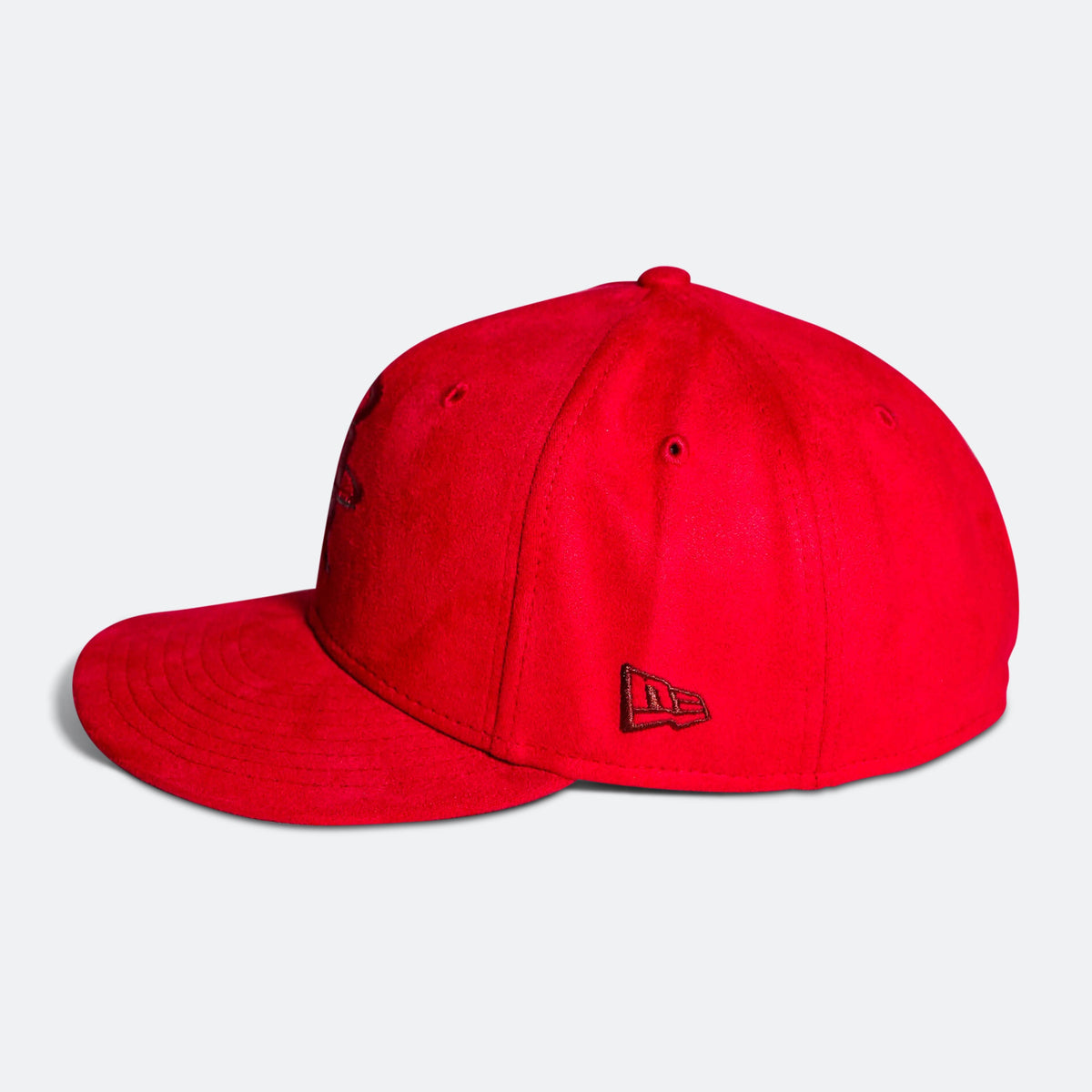 Red baseball cap with New Era flag logo on side