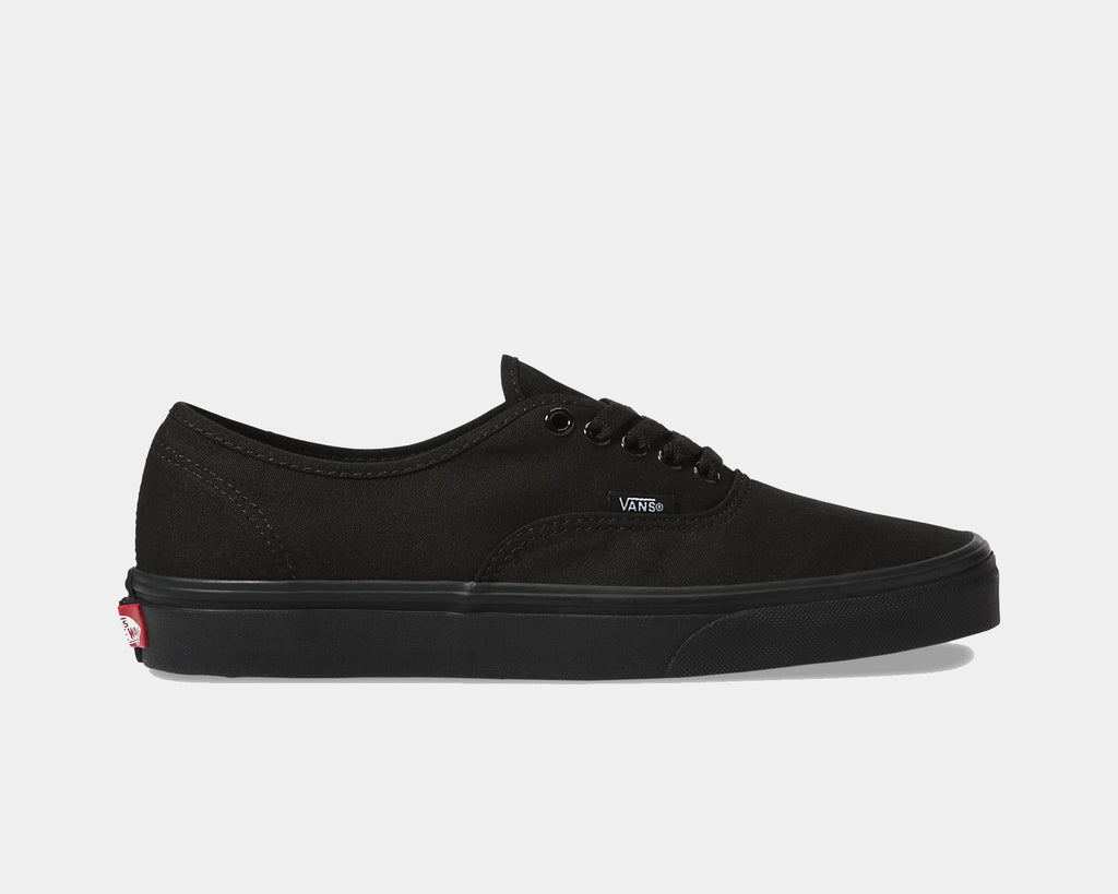 Black low-top sneaker with lace-up front, Vans logo, and red accent at heel