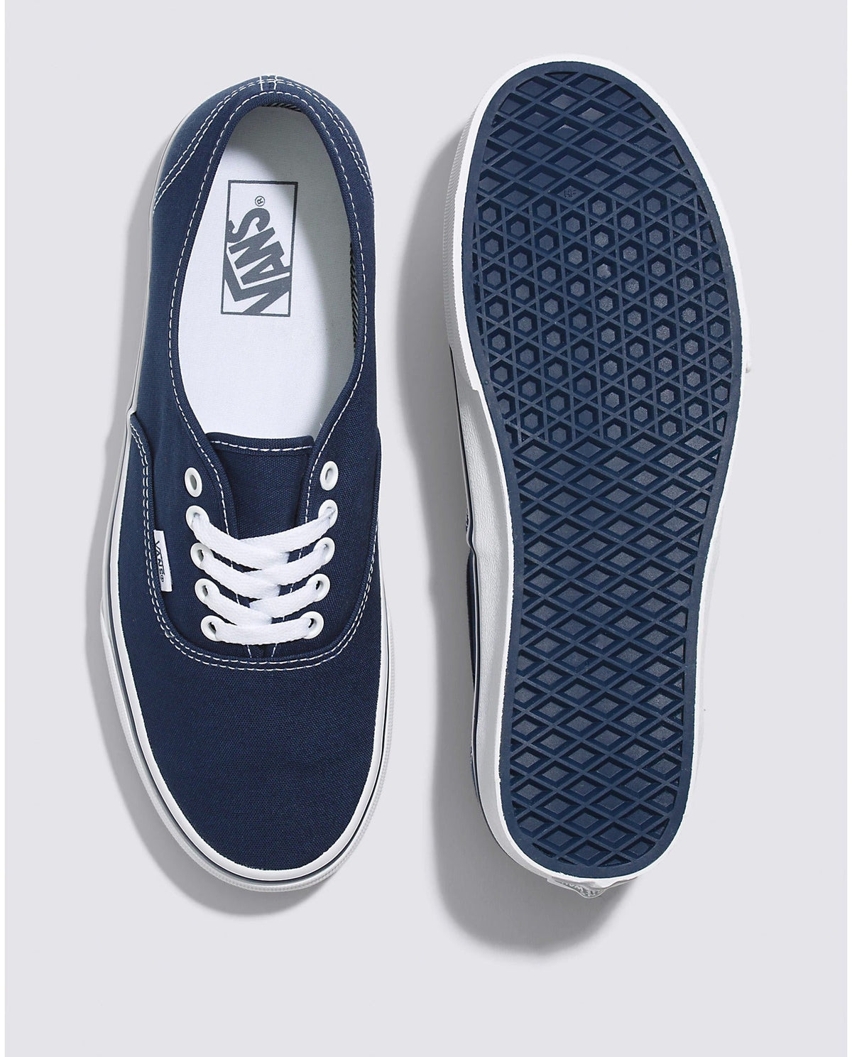 Navy low-top sneakers showing insole and textured rubber outsole tread
