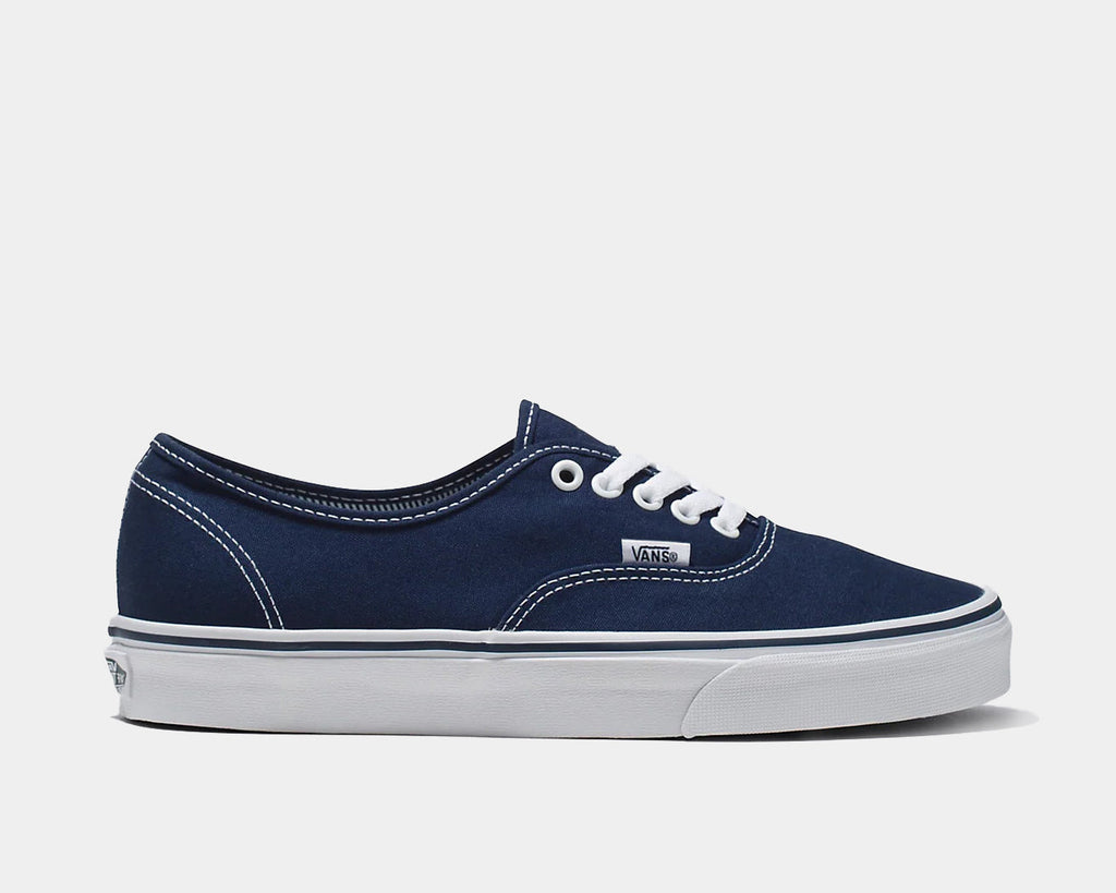 Navy low-top lace-up sneakers with white stitching, Vans logo, and white sole