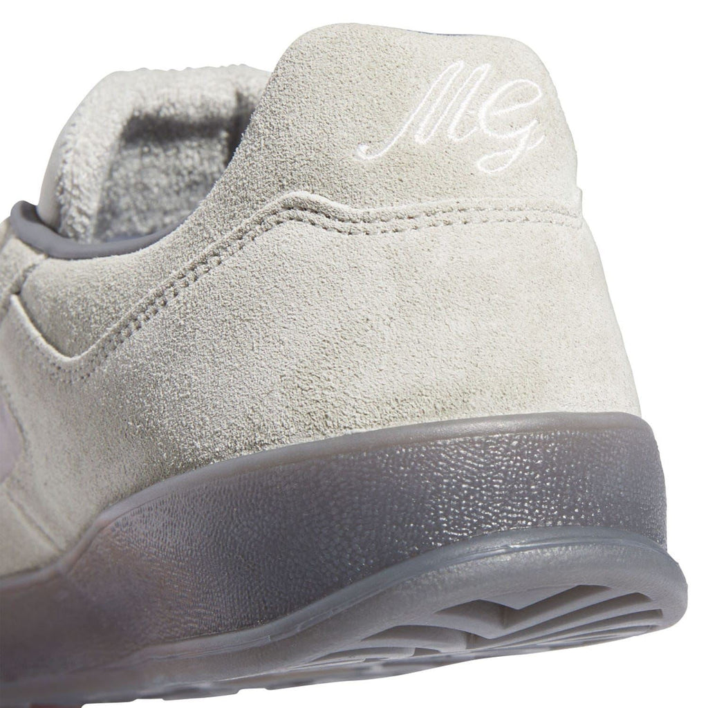 Close-up of beige suede heel with adidas logo on the side and textured finish