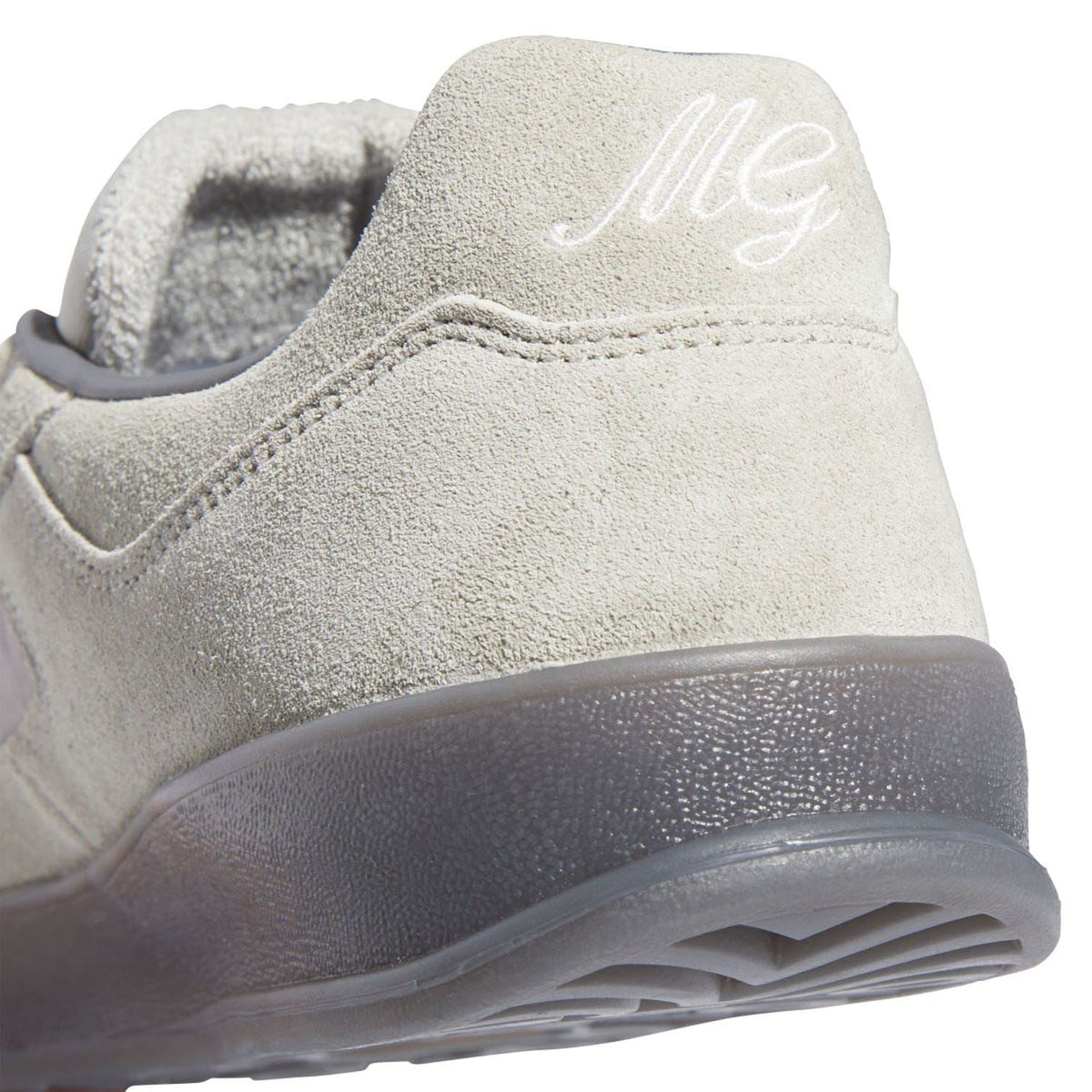 Close-up of beige suede heel with adidas logo on the side and textured finish