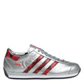 Silver adidas Originals leather sneaker with red diagonal stripe accents and lace-up