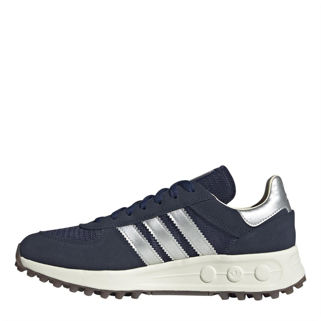 Navy low-top trainers with white Adidas stripes, lace-up closure, and chunky sole