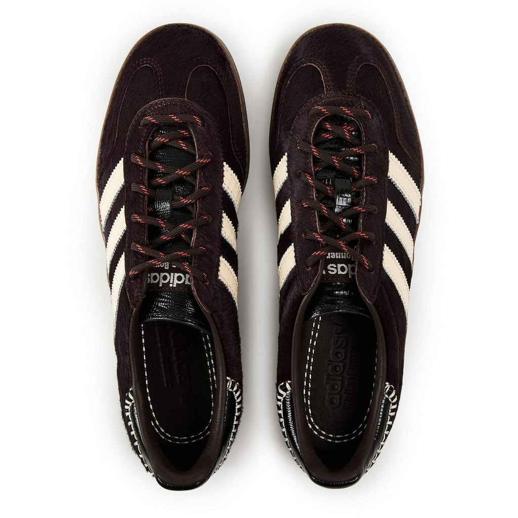 Lace-up pony shoes shown from top: dark brown uppers, white three stripes, black laces.