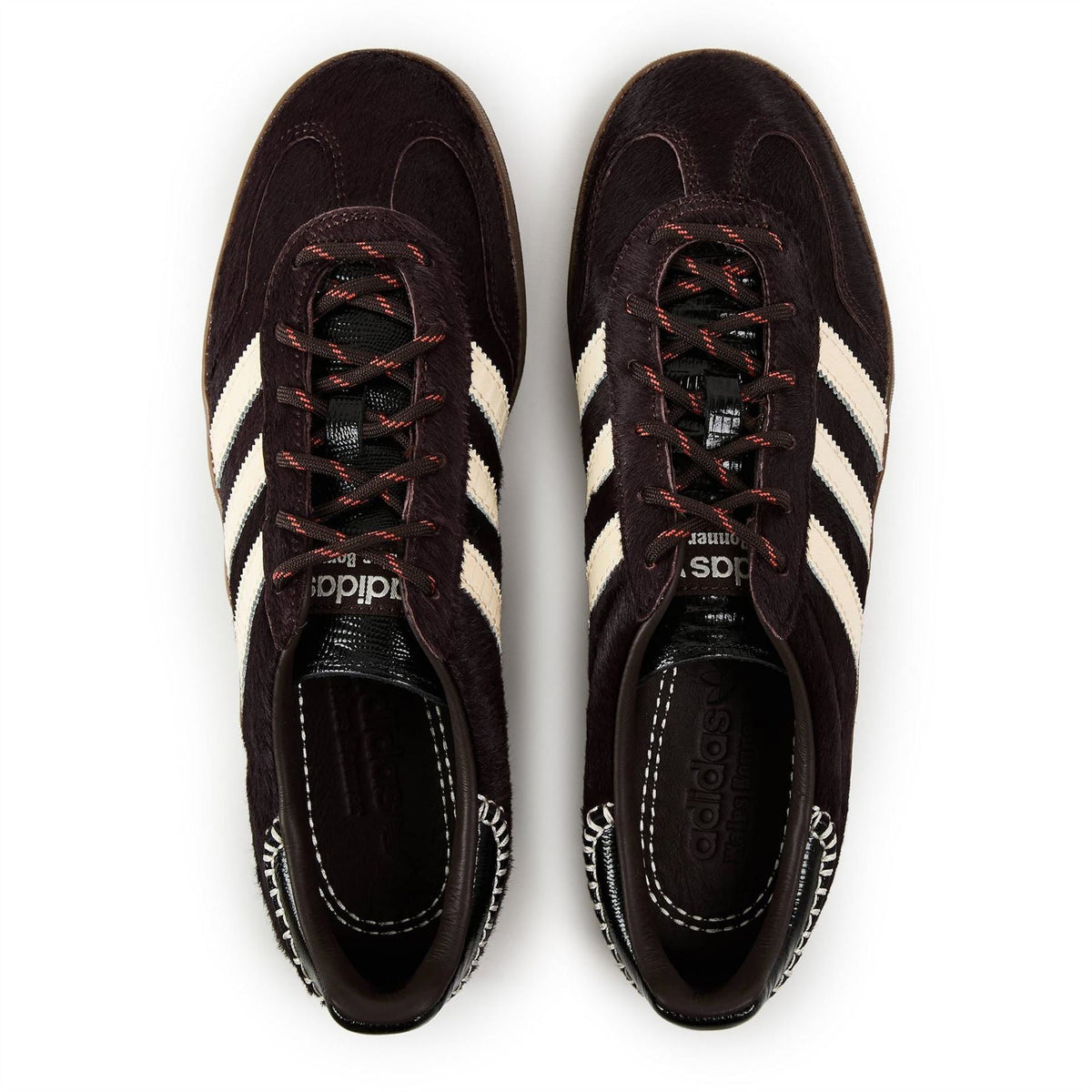 Lace-up pony shoes shown from top: dark brown uppers, white three stripes, black laces.