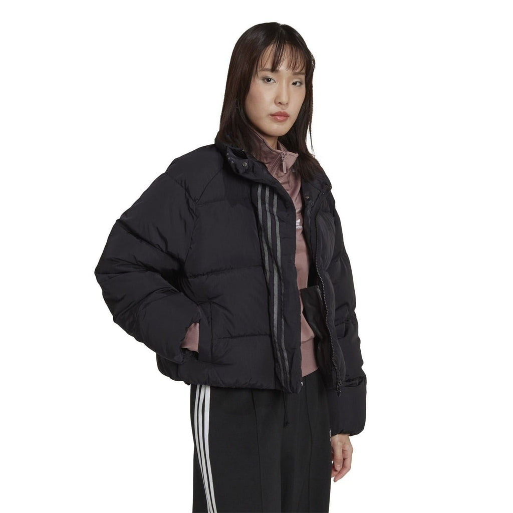 adidas Originals short down jacket displayed on a hanger, featuring a sleek design and quilted insulation for warmth.