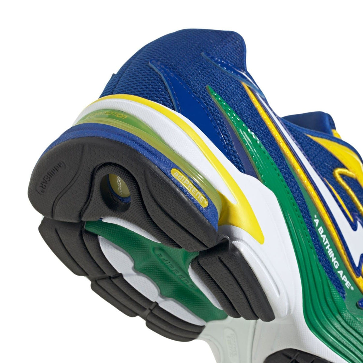 Heel and side close-up with blue mesh, green stripe, yellow detail, cushioned sole