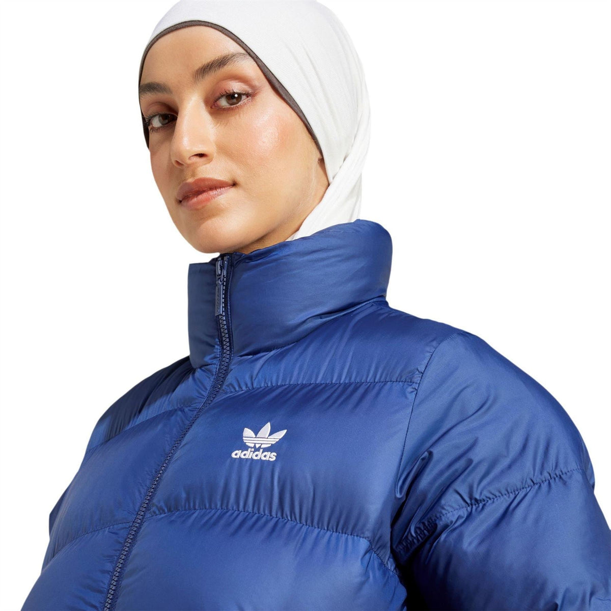 adidas Originals dark blue puffer jacket detail view with small chest logo