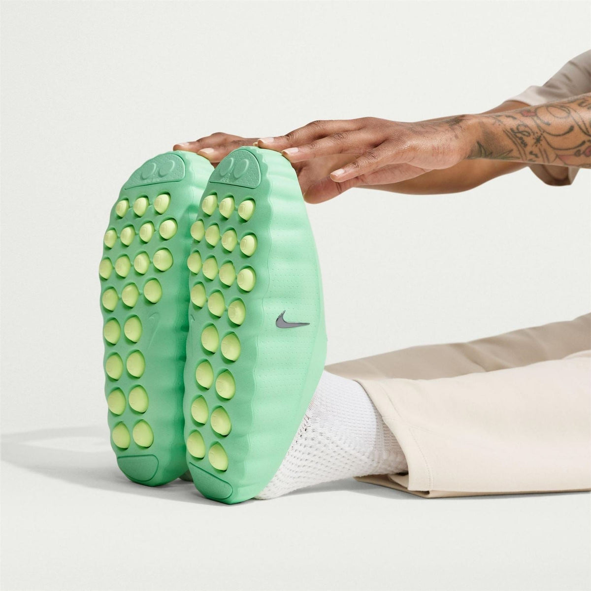 Volt green slide sandals with circular traction studs and perforated upper, held open