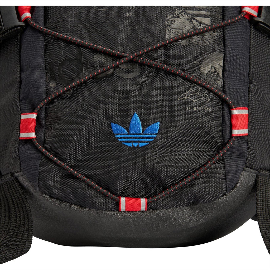 Front panel of dark carbon backpack with blue trefoil logo and red striped trim