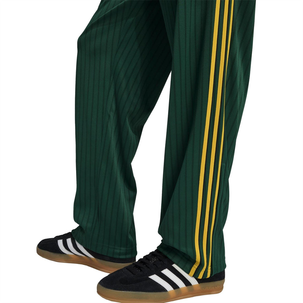 Adidas Originals Firebird track pants with tapered cuffs and yellow side stripes