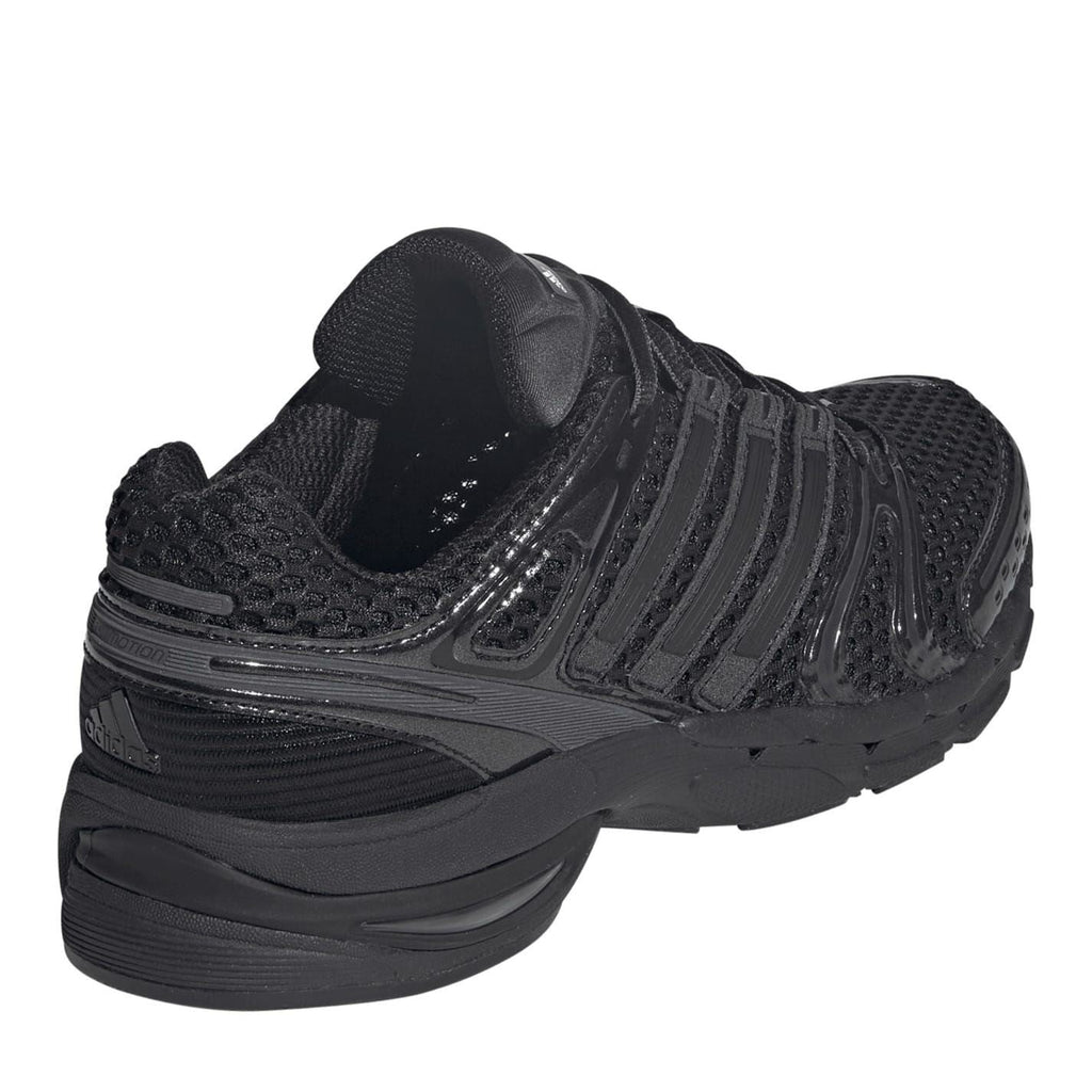 Black sneaker heel and side view with layered cushioning and molded ridges