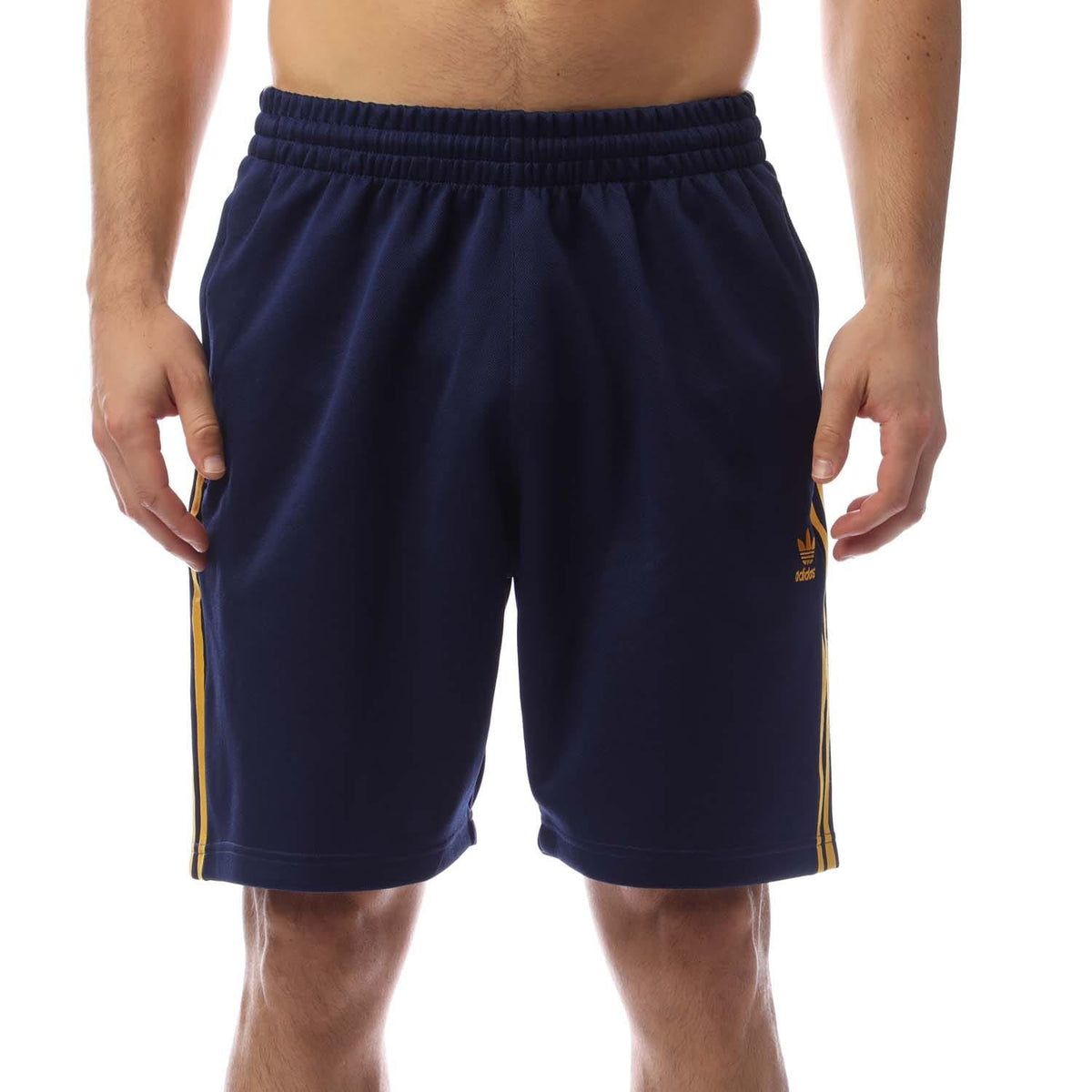 Navy track shorts with elastic waistband and yellow side stripes, adidas logo on leg