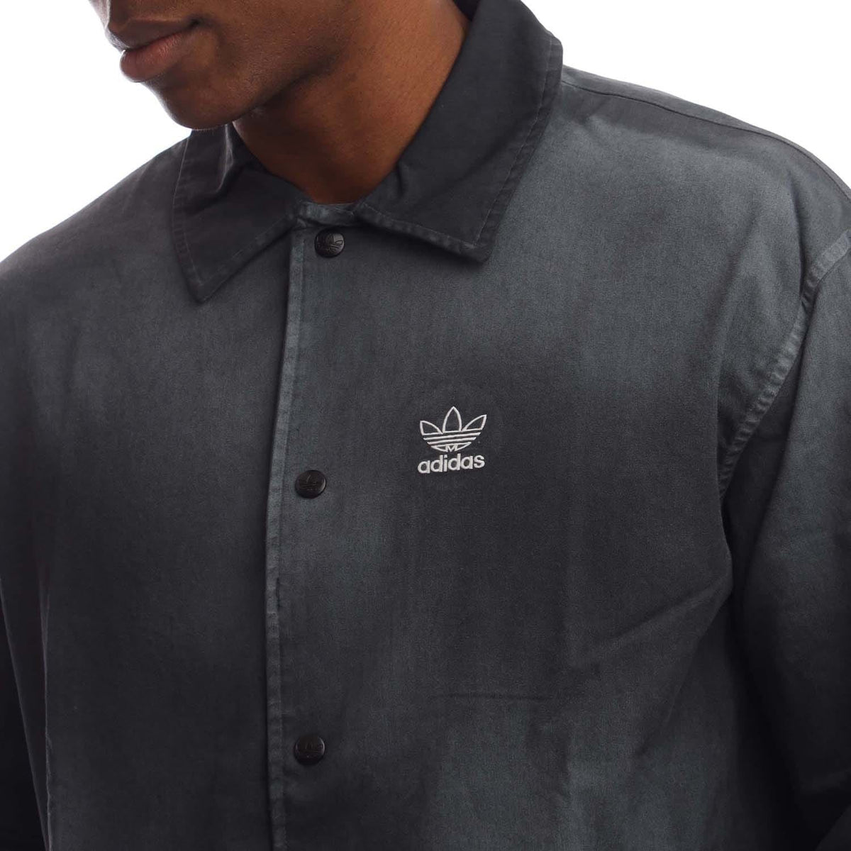 Black coach overshirt close-up with button front and adidas chest logo