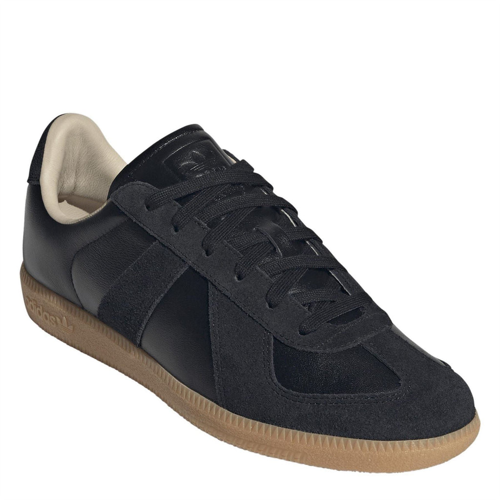 Navy-black adidas Originals sneakers with suede panels, lace-up front, and gum sole