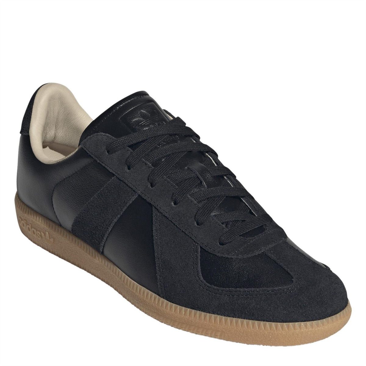 Navy-black adidas Originals sneakers with suede panels, lace-up front, and gum sole