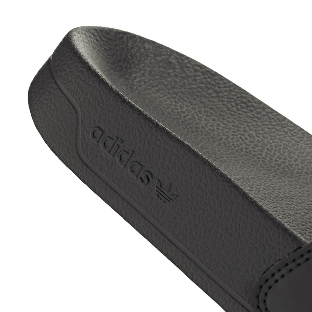 Black footbed with adidas logo emboss and stitched side edge