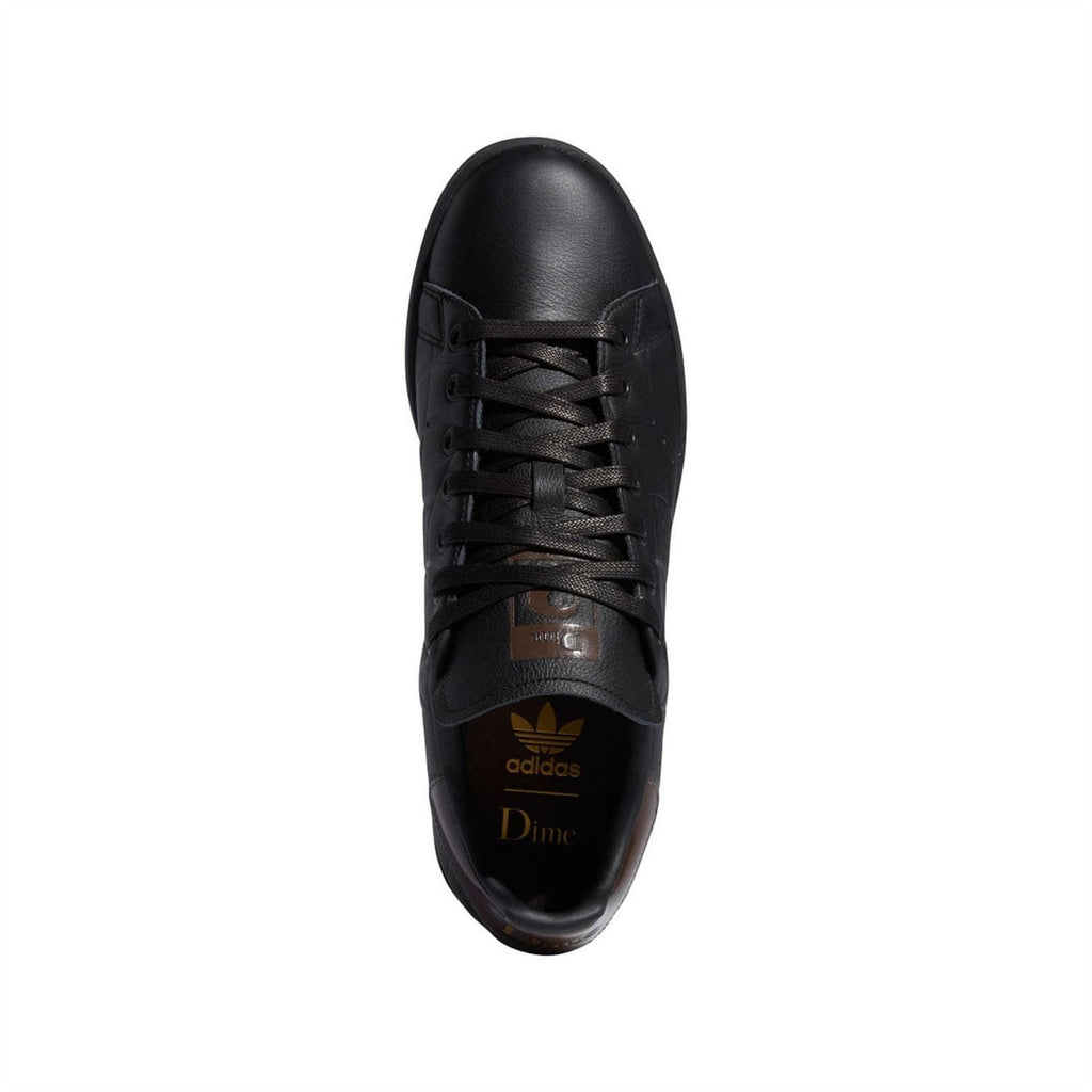 Black lace-up trainers with brown tongue label and textured toe cap