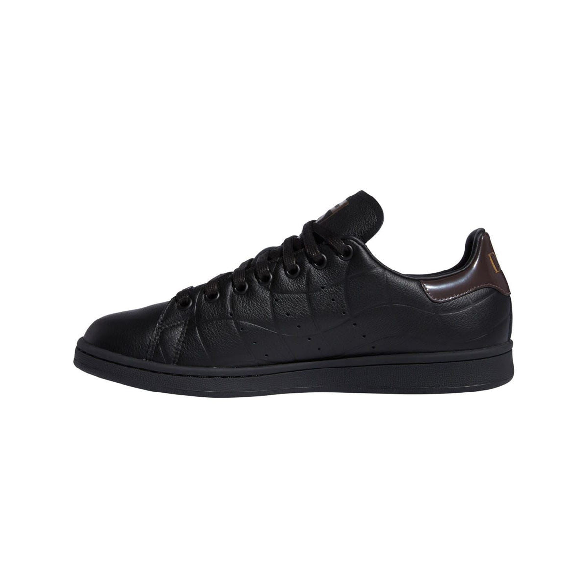 Black low-top lace-up trainers with brown accent heel collar and smooth rubber sole
