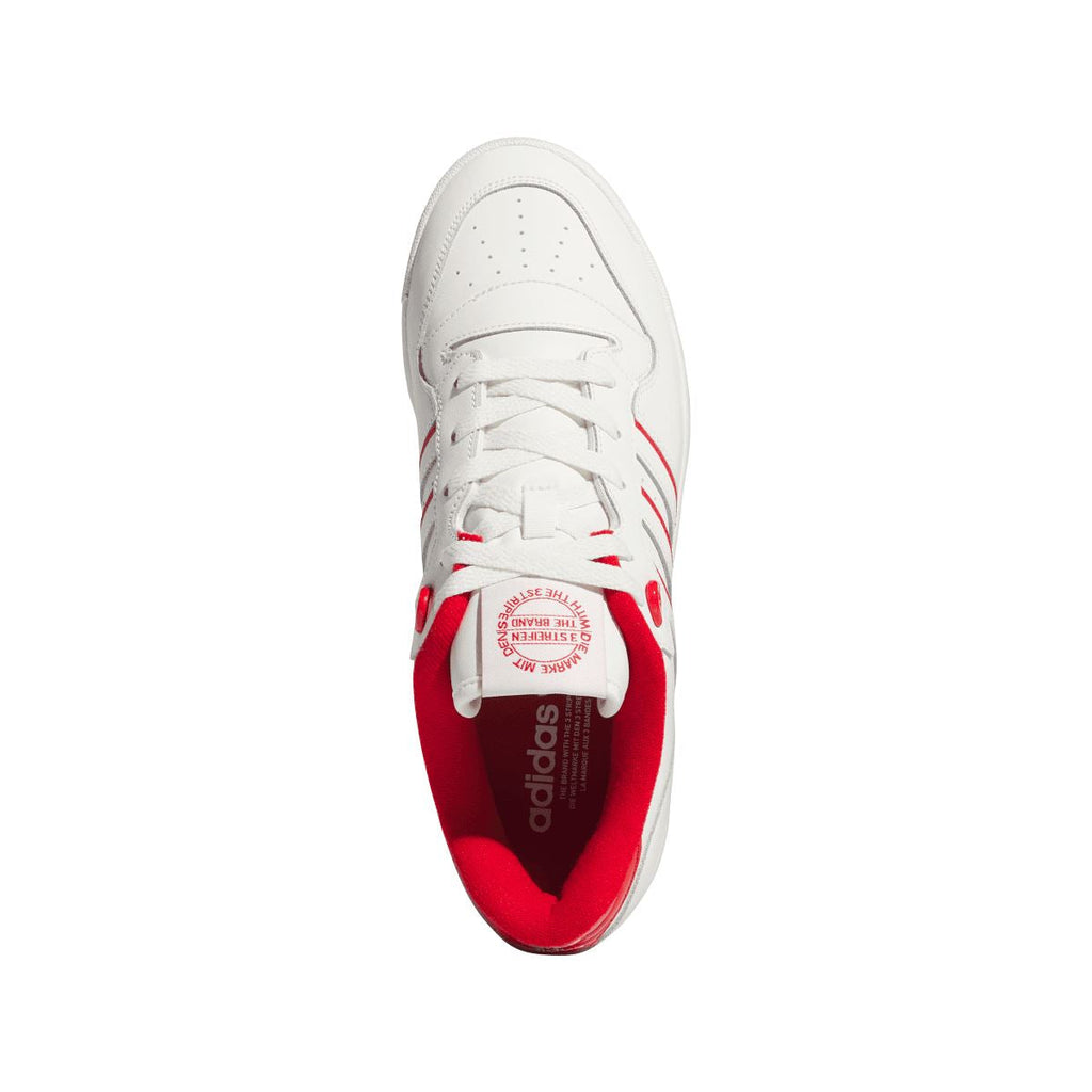 White leather-style sneaker with red inner lining and lace-up front opening.