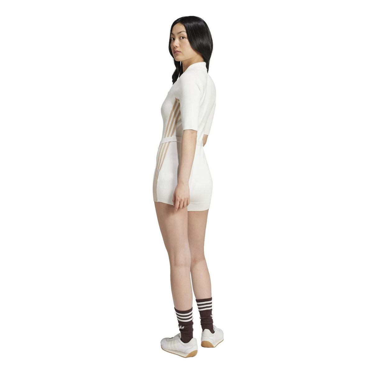 Off-white knit onesie romper side view with vertical stripe panels and ribbed leg cuffs