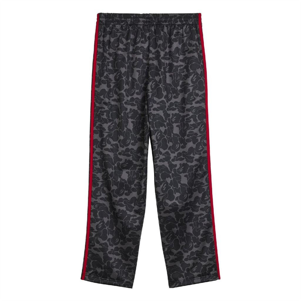 Black camo track pants with red side piping and elastic waistband