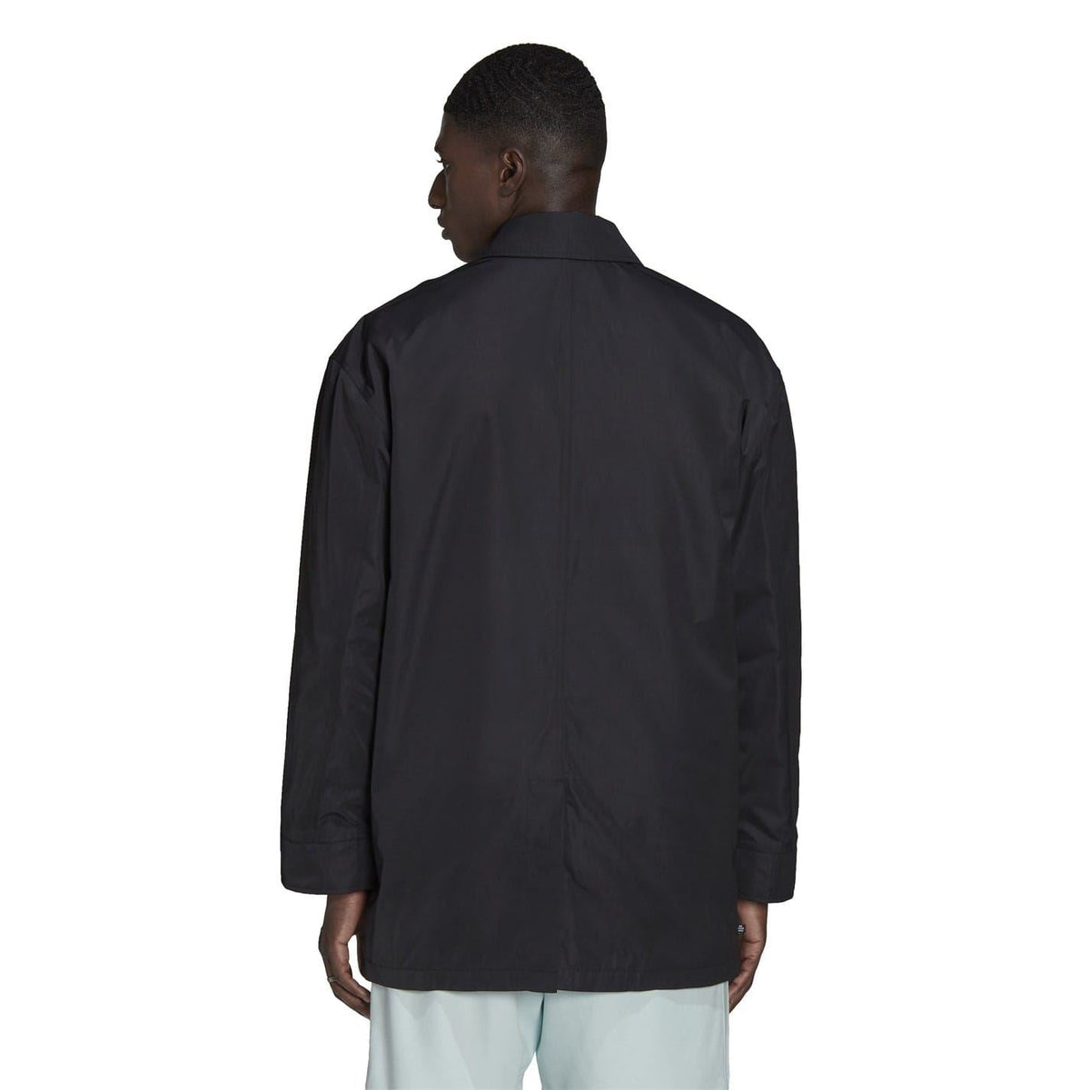 Black men’s jacket back view with long sleeves and button closure.