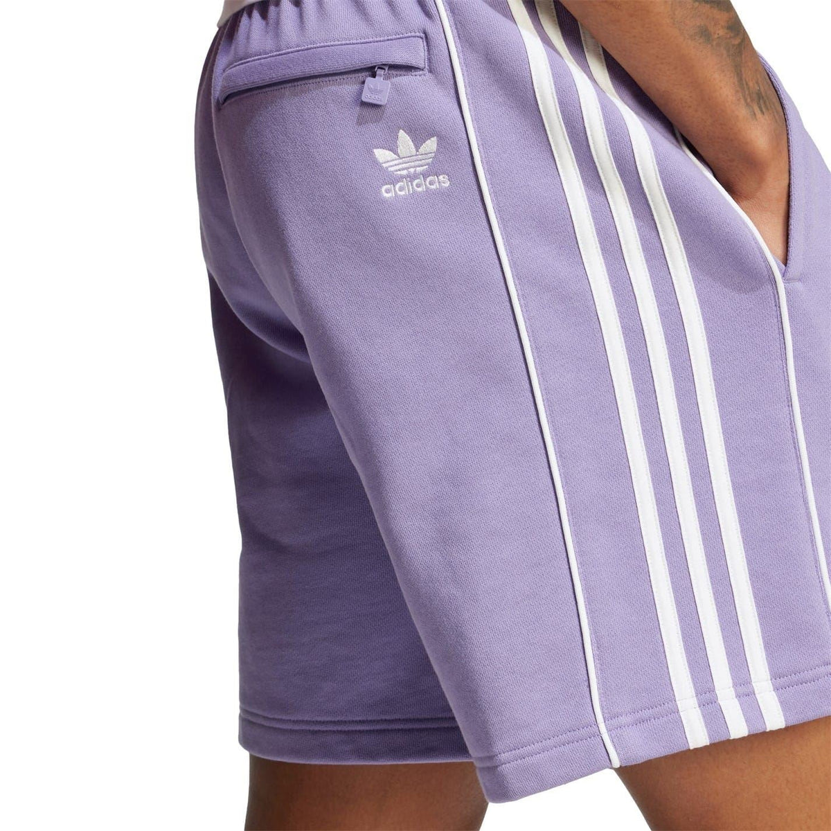 Lavender shorts with adidas logo and three white vertical stripe panels on side