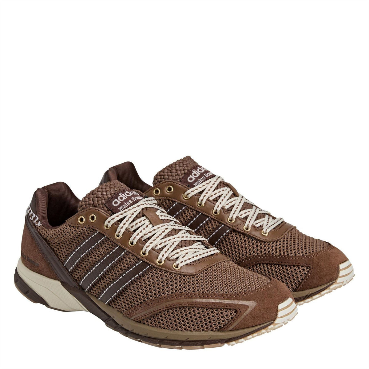Brown mesh lace-up running shoes with white stripes, cream sole, and brown lace detail.