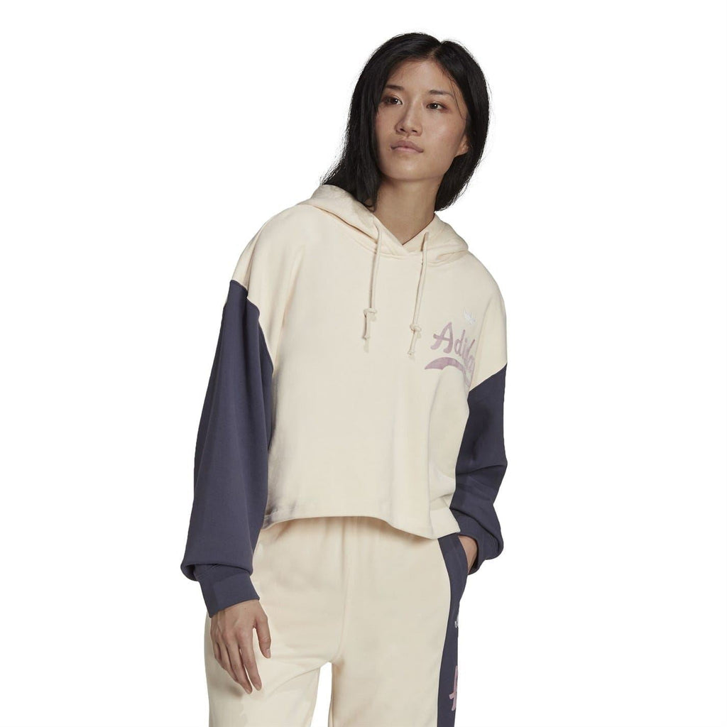 Front view cropped hoodie in cream with navy sleeves and Adidas logo, drawstrings