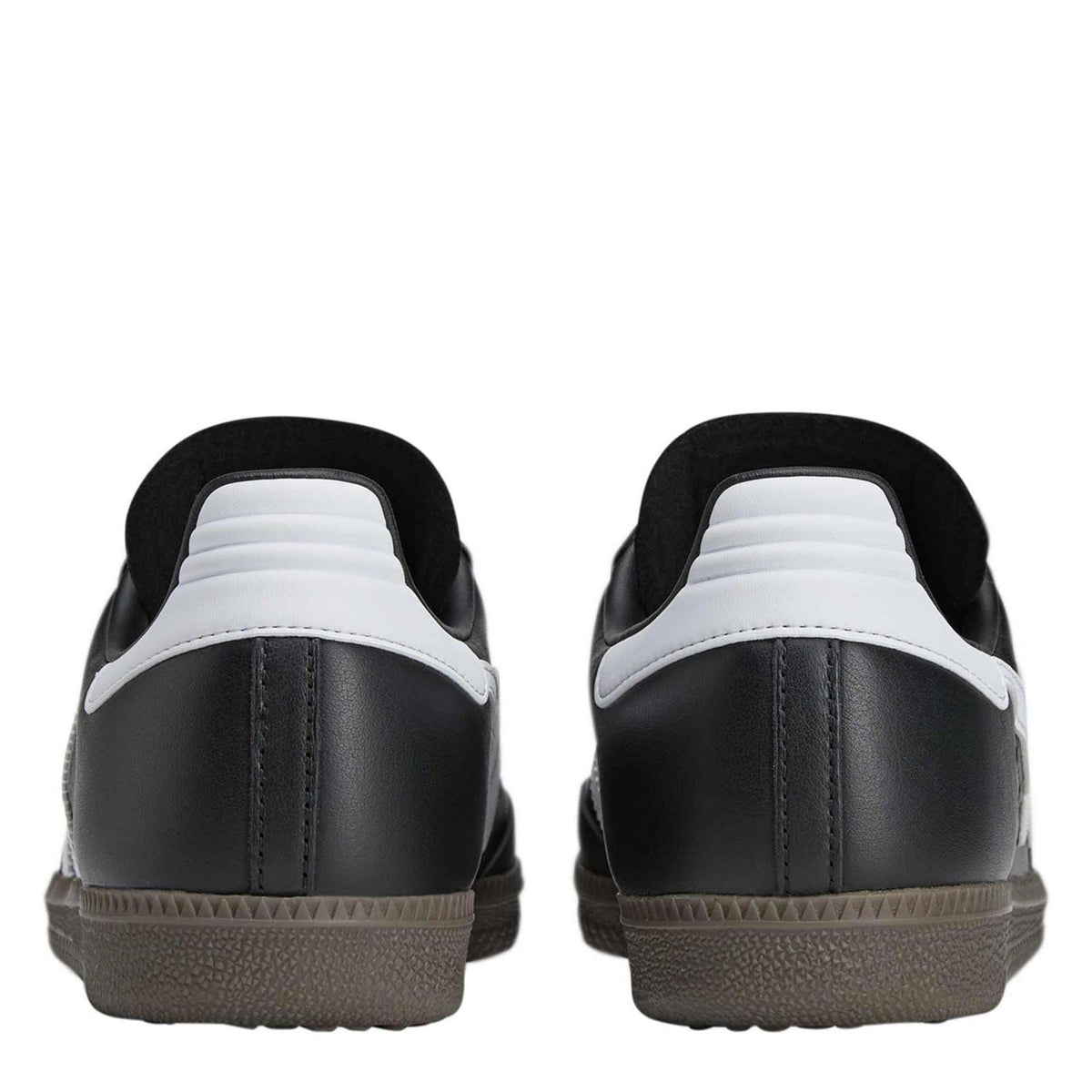 Black low-top sneakers with white heel panel and stitched back, lace-up