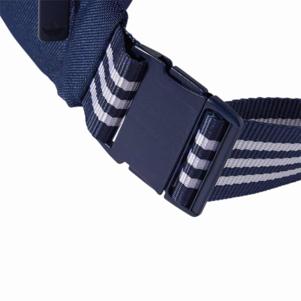 Adjustable dark indigo webbing strap with plastic buckle on waist bag