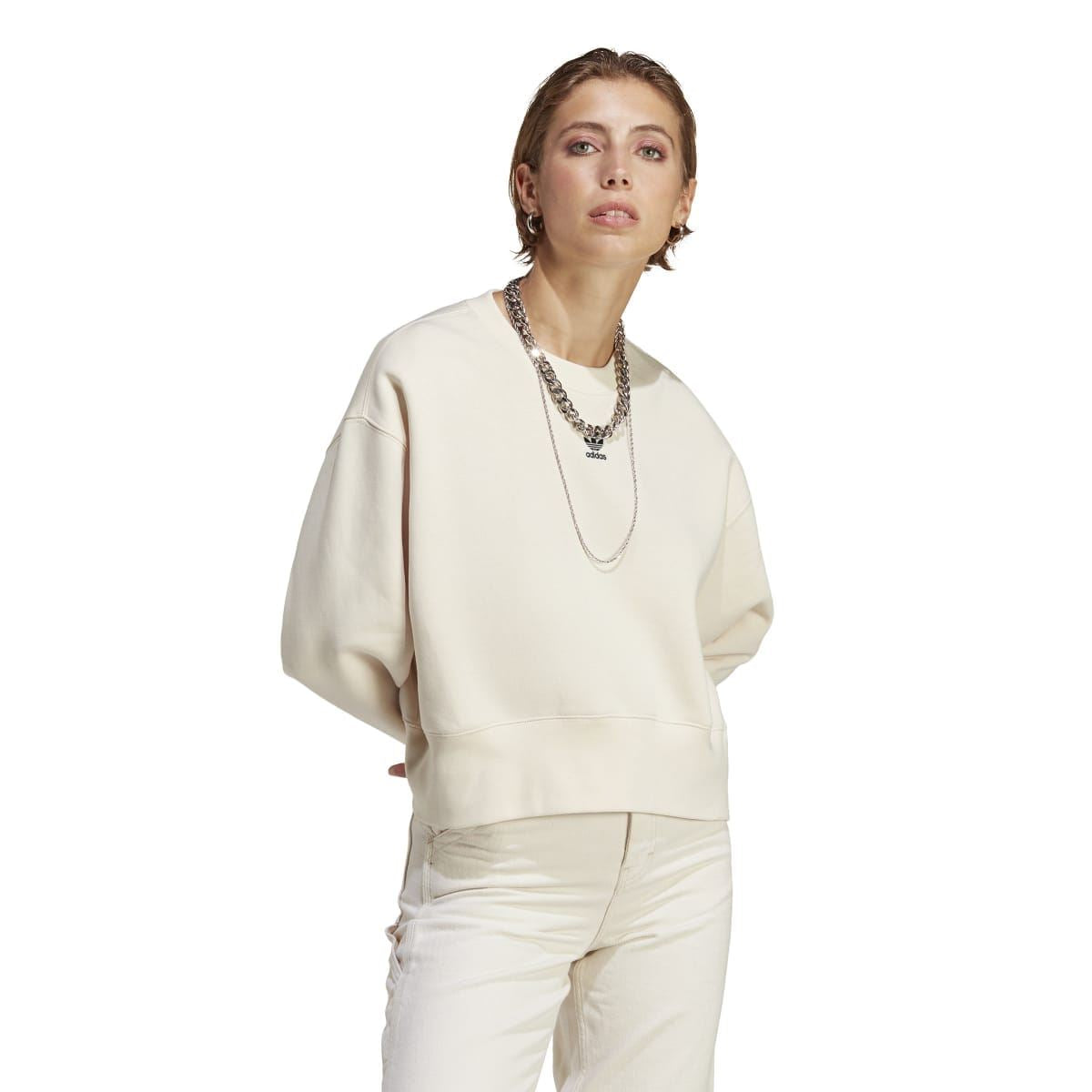 Cream crewneck sweatshirt with ribbed cuffs and hem, worn by model.
