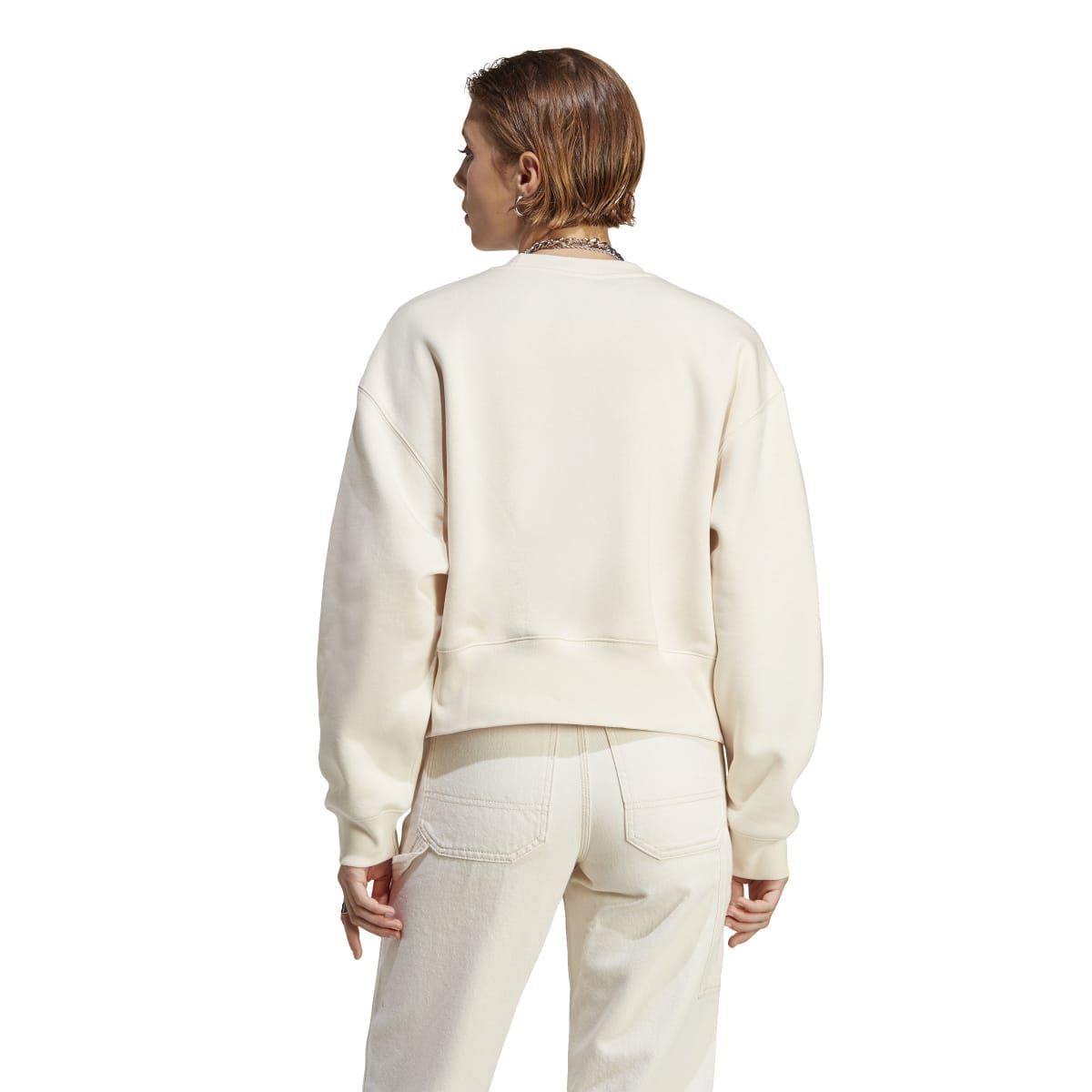 Cream crewneck sweatshirt, back view with ribbed cuffs and hem.